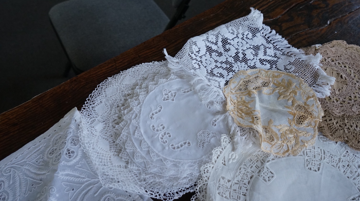 A 19th century large linen cut work collar, together with various sets of circular cut work mats, a tasselled pelmet and a collection of bobbin lace and tatting worked mats etc., Condition - mostly good